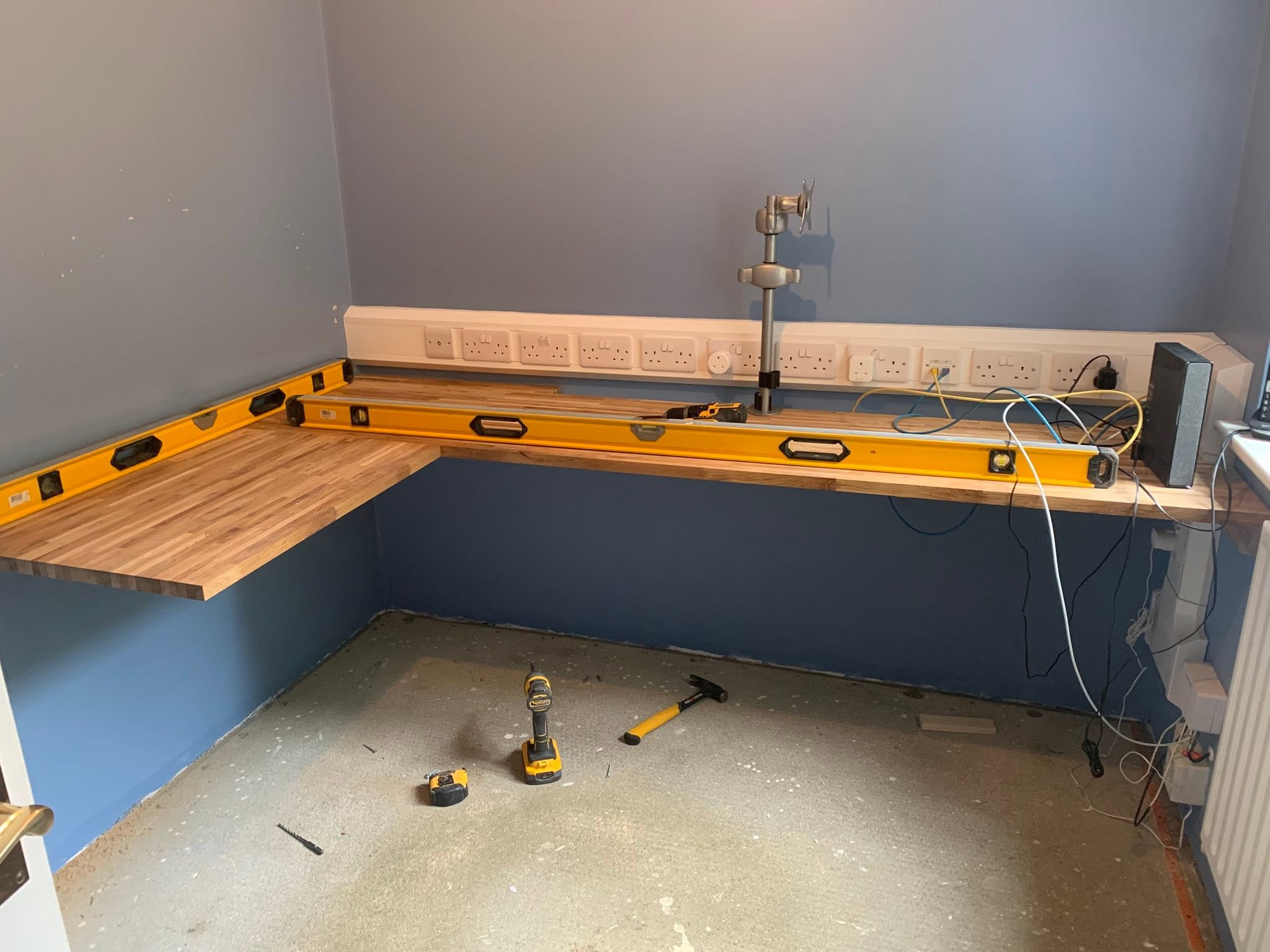 Oak corner desk being fitted in a home office